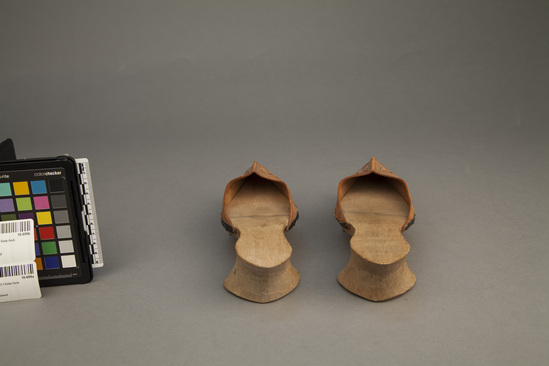 Hearst Museum object titled Shoes, accession number 10-699a,b, described as Woman’s street shoes showing Japanese influence in clog, and French influence in heel; tooled leather tops and wood soles.