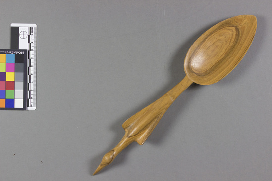 Hearst Museum object titled Spoon, accession number 5-2664b, described as Half of a pair of wooden salad servers; spoon with stylized bird handle; length 11¼ inches. Muzumina wood (Kiskia acuminata).