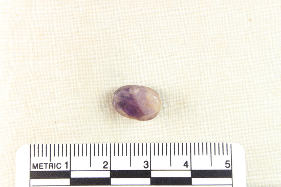 Hearst Museum object 8 of 8 titled Scarab, accession number 6-13763, described as Amethyst scarab, uninscribed. Length 12.2 mm, width 8.3 mm, height 5.9 mm.