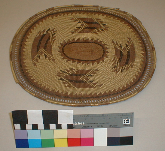 Hearst Museum object titled Basket, accession number 1-27058, described as Plaque or mat. Oval, twined. 4 large geometric designs in field. Openwork within rim.