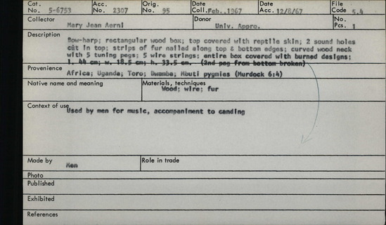 Documentation associated with Hearst Museum object titled Lyre, accession number 5-6753, described as Bow-harp; rectangular wood box; top covered with reptile skin; 2 sound holes cat in top; strips of fur nailed along top and bottom edges; curved wood neck with 5 tuning pegs; 5 wire strings; entire box covered with burned designs; l. 44 cm; w. 18.5 cm; h. 33.5 cm (2nd peg from bottom broken)