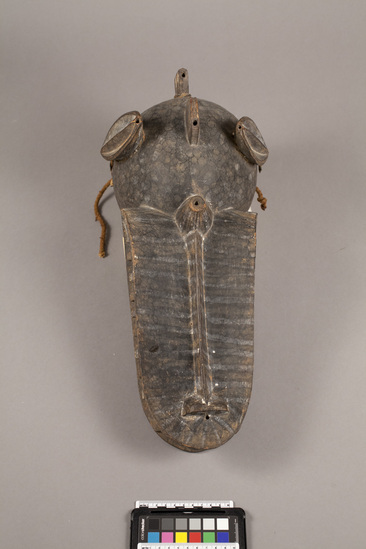 Hearst Museum object titled Helmet mask, accession number 5-5343, described as Carved, wooden, “fire spitter, helmet mask. Painted stripes and dots form decoration. L = 46.5 cm