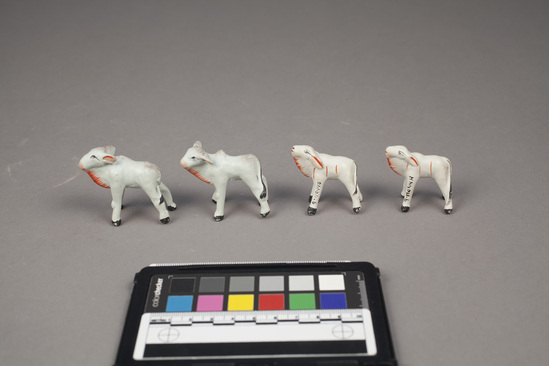 Hearst Museum object 5 of 5 titled Toy cows, accession number 9-11044a-h, described as Toy cows (8); painted clay;  large, each:  7 cm. length; 2 1/2 cm. width; small, each: 5 1/2 cm. length; 2 cm. width