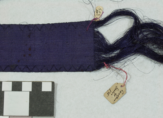 Hearst Museum object 2 of 3 titled Belt, accession number 11-207, described as Belt or ribbon of fiber, violet.