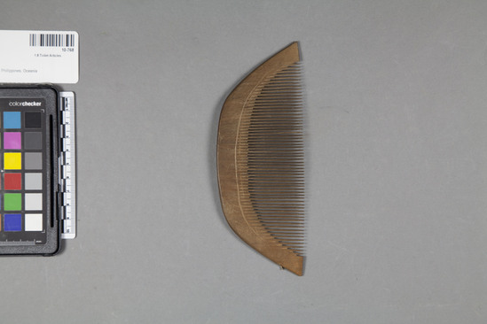 Hearst Museum object 2 of 2 titled Comb, accession number 10-768, described as Wooden comb; curved back; incised line on each side.