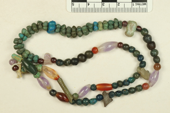 Hearst Museum object 3 of 3 titled Beads, accession number 6-20811, described as beads: carnelian, blue rosettes, etc. XII Dynasty, Middle Empire