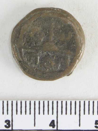 Hearst Museum object 4 of 6 titled Coin: æ 10 nummia (decanummium), accession number 6-23133, described as Obverse description: two frontal figures, soldiers perhaps, separated by a cross.. Reverse description: an I surmounted by a cross potent Left A; Right W. In exergue below AAN. Diameter 1.6 cm, weight 4.23 grams. Condition: fair.
