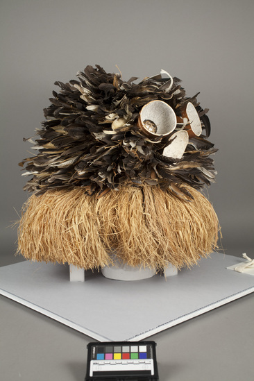 Hearst Museum object titled Mask, accession number 5-1649, described as “Mwela” mask; West Basuku; feather covered netting face mask with three pieces of gourd attached. Raphia neck band. Used during circumcision ceremonies. Diameter approximately 63.5 cm.