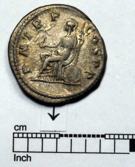 Hearst Museum object 8 of 8 titled Coin: billon denarius, accession number 8-4355, described as Coin; AR; Billon Antoninianus; Roman. 4.66 grams, 23 mm. Elagabalus, 218 AD. Rome, Italy. Obverse: IMP CAES M AVR ANTONINVS AVG, bust r. radiate. Reverse: P M TR P COS P P, Roma seated l.