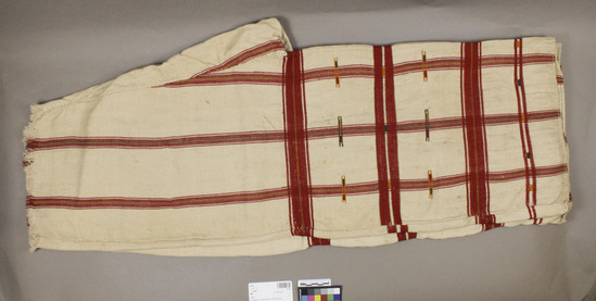 Hearst Museum object titled Underpants, accession number 3-116, described as Man’s underpants; off white cotton; basket weave with vertical, red, orange and green stripes; pant legs brocaded horizontally; fabric fringed at waist; pant legs hemmed; approximately 96 cm long, inseam 50 cm long Remarks: Appears to go with 3-114. Pattern also as 3-115