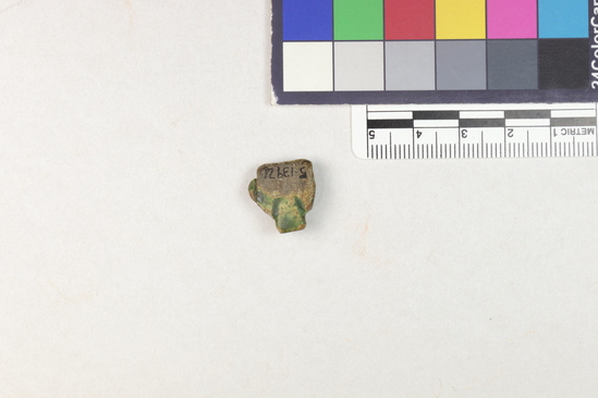 Hearst Museum object 3 of 6 titled Amulet, accession number 5-13971, described as Amulet: anthropomorphic, head with much of features worn off. Greenish glaze on eyes, top of head and back of head.