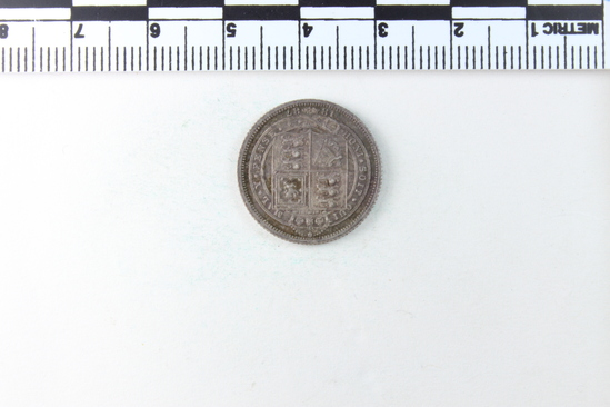 Hearst Museum object titled Coin, accession number 7-2826, described as Coin: AG: O- VICTORIA. DEI. GRATIA BRITT. REGINA. F:D: Reverse- HONI.SOIT.QVI. MAL. Y. PENSE -1887; 2.82 grams.