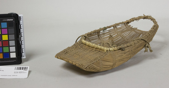 Hearst Museum object 2 of 2 titled Cradle toy, accession number 1-9454, described as Uses old shoe laces for straps, openwork twining.