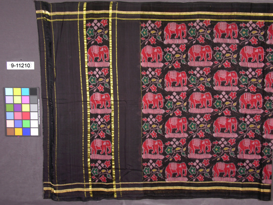 Hearst Museum object titled Sari, accession number 9-11210, described as Sari; cotton patola (weft ikat); multicoloured design of elephants and flowers on a black ground; length approximately 540 cm, width 110 cm.