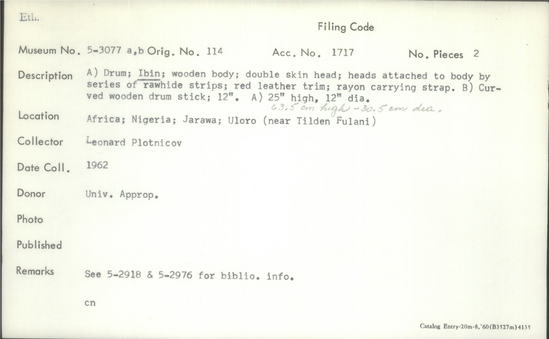 Documentation associated with Hearst Museum object titled Drum and drumstick, accession number 5-3077a,b, described as A) Drum; Ibin; wooden body; double skin head; heads attached to body by series of rawhide strips; red leather trim; rayon carrying strap. Height: 25 inches; diameter: 12 inches. B) Curved wooden drum stick; 12 inches.