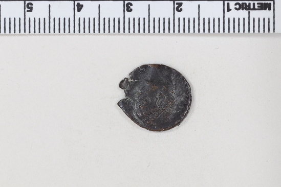 Hearst Museum object titled Coin: æ 4, accession number 8-7384, described as Coin, AES Follis 4.         1.76 grams. 15mm. Obverse: Constantius II Reverse: Wreath containing   VOLXX  MVLTXXX