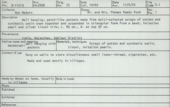 Documentation associated with Hearst Museum object titled Wall hanging, accession number 9-11219, described as Wall hanging; patch-like pockets made from multi-coloured scraps of cotton and synthetic satin sewn together and suspended in triangular form from a band; imitation pearl and silver tinsel trim; Length 89 cm., Width at top 97 cm.