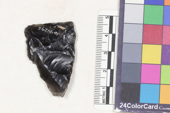 Hearst Museum object 2 of 2 titled Projectile point fragment, accession number 16-14295, described as Projectile point; obsidian; triangular; weight: 6.82 grams; length: 4.27 cm; width: 2.89 cm; depth: 0.66 cm; convex sides; straight, thinned base.