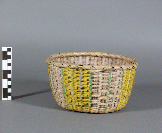 Hearst Museum object titled Basket, accession number 10-1312, described as Wicker basket, painted green & yellow stripes; round; flat bottom; open mouth; 9 1/2” dia.