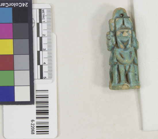 Hearst Museum object 6 of 11 titled Amulet (gods), accession number 6-22068, described as Four-sided amulet of blue faience, showing faience, showing Horus (two sides), Harpocrates, and Serket; length 56 mm.