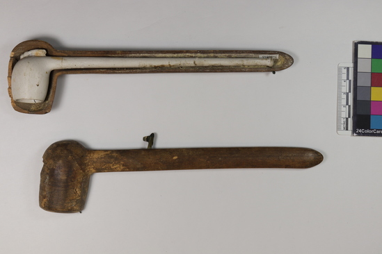 Hearst Museum object 6 of 6 titled Pipe w/ box, accession number 7-9664a-c, described as Pipe with box. (a) Pipe, white clay, long stem, foot with full relief of a bee, incised “Gambie a Paris m * M Depose 1079;” broken. Length 20 cm. Diameter of bowl 2.5 cm. (b), (c) Box, two pieces, wood, with brass catch, stained, broken. Length 22 cm. Diameter of bowl 3 cm.