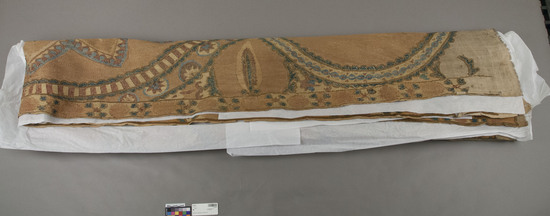 Hearst Museum object titled Wall hanging, accession number 9-15030, described as Wall hanging.  Cotton, silk, camel's hair?  Plain weave, embroidered.  Natural ground, varicolored designs.  Geometric, foliage motives.  118 inches by 56 inches.