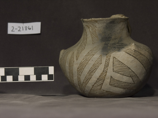 Hearst Museum object titled Jar, accession number 2-21861, described as Round, triangular jar. 3 "points"; gray with brown striped zigzag design, handle.