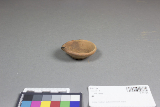 Hearst Museum object titled Oil lamp, accession number 9-11724, described as oil lamp; terracotta; each has spout for wick. Width across including spout: 5.8 cm