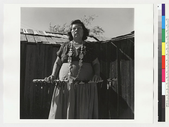 Hearst Museum object titled Black-and-white negative, accession number 15-20249, described as Essie Parrish holding costume; abalone and clamshell necklace; two cloth covered sticks