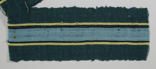 Hearst Museum object titled Textile fragment, accession number 5-11219, described as textile sample (section of narrow band weaving): green side panels; central stripe of maroon flanked by pale blue, black, and yellow.