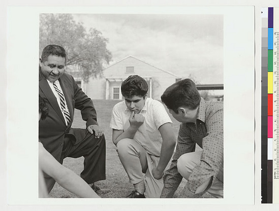 Hearst Museum object titled Black-and-white negative, accession number 15-19492, described as Indian boys and Sidney Parrish playing stick game