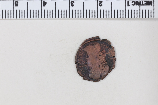 Hearst Museum object titled Coin: æ 4, accession number 8-7048, described as Coin, Aes Follis 4,  ___ grams. ___ mm. Obverse: Constantius II. Reverse: Wreath containing VOL / XX / MVLT / XXX.