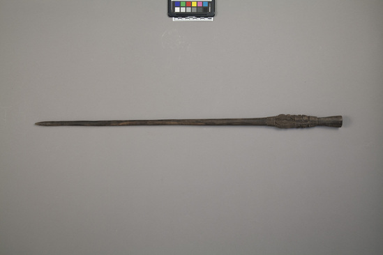 Hearst Museum object titled Walking stick, accession number 11-39839, described as Sparring club/ walking stick/ swagger stick of black wood decorated with incised patterns on upper end. Finial carving of double squatting figures. 81.5 cm length