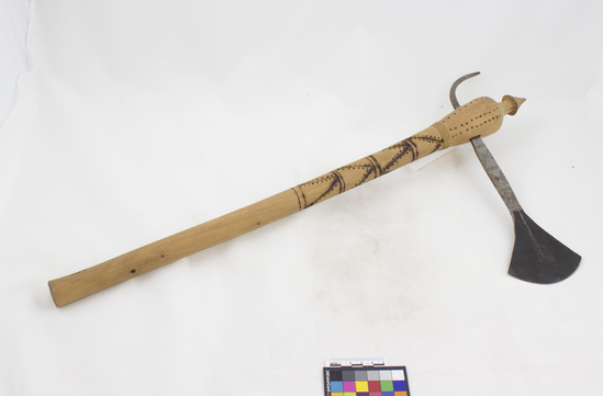 Hearst Museum object titled Axe, accession number 5-2141, described as Axe; Mpophive; incised wooden handle w engraved steel axe-head, overall length 23 7/8 inches. Axe head is 12 inches length.