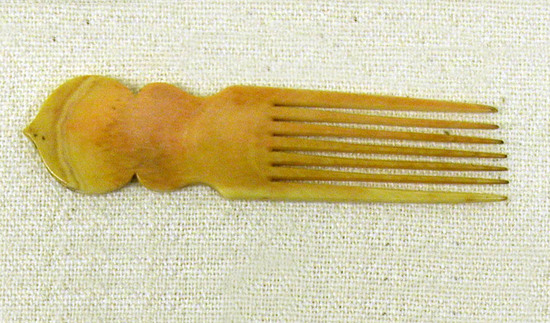 Hearst Museum object titled Comb, accession number 9-21320, described as Comb. Ornamental ivory comb with peach tip. For mustache? Seven teeth approximately 8 cm long; width:  2.1 cm; 3 mm thick.