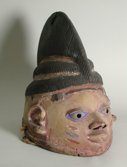 Hearst Museum object titled Mask, accession number 5-15489, described as mask, wood, handcarved;  representing female head;  stylized facial features in yellow pigment; black hair and headdress in low relief;  H 26.3 cm x W (nose to back of head) ca 31.0 cm.