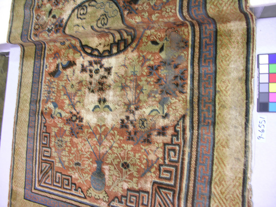 Hearst Museum object titled Rug, accession number 9-6551, described as Rug; rusty, maroon-rose, & camel's hair brown; fretted border (1 blue-green fret & small guard); central circle with deer.