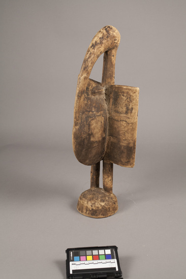 Hearst Museum object titled Carved bird figure, accession number 5-13551, described as Hornbill carving; standing hornbill with rectangular wings; hemispherical base; mottled brown-stained wood; height 55 cm