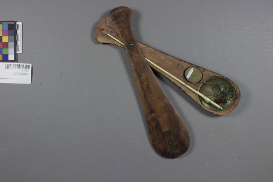 Hearst Museum object 3 of 3 titled Scale, accession number 9-21344a-c, described as Pair of scales in wood case. Brass weight (c) hanging by green silk cord from calibrated ivory or walrus-tooth beam. Bowl (a) of the same metal for pinched-off silver. Beam (also a) to be held by one of three green silk threads, according to weight of silver. Center thread with red tassel. Closure of wood case (b) with copper(?) latch; rivet also copper(?). Length of beam: 25 cm; width of bowl: 6 cm; length of case: 29 cm; greatest width: 7 cm.