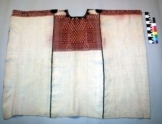 Hearst Museum object 1 of 3 titled Huipil, accession number 3-17, described as Woman’ shirt (huipil); white cotton; brocaded with red and yellow; stitched in dark blue; appliqued in dark blue ribbon; approximately 78 cm long, 96 cm wide For the color red the fiber is silk and the dye result is cochineal