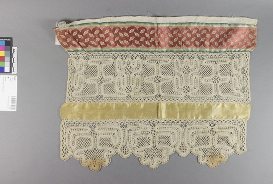 Hearst Museum object titled Lace, accession number 7-3482, described as Remnant; Idria (Russian tape) lace; linen; geometric; ribbons, silk, satin and satin brocade; red, yellow, blue