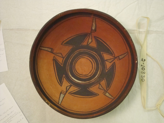 Hearst Museum object 1 of 2 titled Bowl, accession number 2-10830, described as Ceramic, redware, circular design on interior in black and white, black rim and framing lines, one area of rim cracked and repaired.