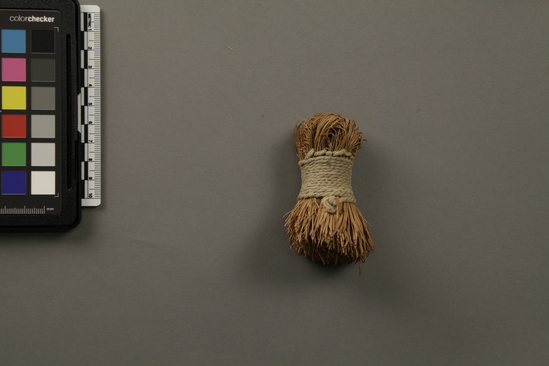 Hearst Museum object titled Brush, accession number 1-13959, described as Made of shredded bark.  Tubular shaped, gathered together with cotton twine at center.