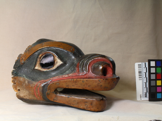 Hearst Museum object 3 of 9 titled Mask, accession number 2-10870, described as Bear head mask, decorated with strips of copper; dark brown glass eyes; wood painted black (?), red and white. Had fur cap attached, now long since destroyed by moths.