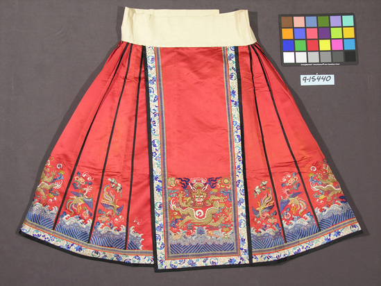 Hearst Museum object titled Skirt, accession number 9-15440, described as Skirt; silk; satin, embroidered; red ground, multicolored embroidery; 37 inches long; dragon, bird, Buddhist symbol motives.