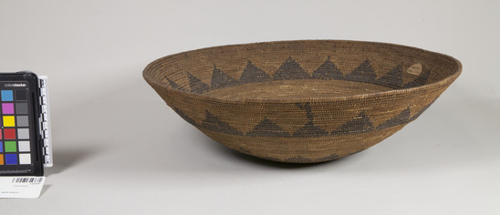 Hearst Museum object 2 of 3 titled Basket, accession number 1-224797, described as Coiled, 3-rod foundation, basin shaped, red-brown designs of two horizontal bands of triangles with points up, circle around center.  Note the anomalous additions to the designs near the closure of the bands. Sedge root and split redbud shoots sewing materials. Starting knot twined.