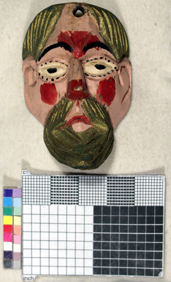 Hearst Museum object titled Toy mask, accession number 3-15590, described as Carved wooden toy mask; painted pink face