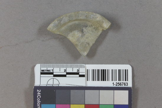 Hearst Museum object titled Glass fragment, accession number 1-256763, described as clear glass-white base fragment