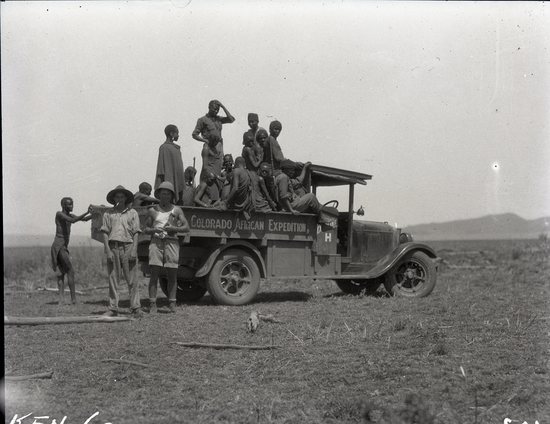 Hearst Museum object titled Black and white negative, accession number 15-32304, described as 4" x 5" Negative. N'jemps Kidogo people ride on the flatbed of the Colorado African Expedition truck. Two members of the Expedition pose with the truck.  Hoefler's original description: "On 'movie location' in remotest Africa. All native Africans love to ride on the white man's "go-fast moto" (motor car), so it is no trick at all to secure plenty of help whenever and wherever needed. This photograph was taken on the flats near Lake Baringo in the Great Rift Valley, and shows the first motor truck to every reach this lake. On the shores of Lake Baringo. The N'jemps Kidogo were very keen on riding in the trucks, so we always had plenty of help in the field.