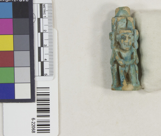 Hearst Museum object 8 of 11 titled Amulet (gods), accession number 6-22068, described as Four-sided amulet of blue faience, showing faience, showing Horus (two sides), Harpocrates, and Serket; length 56 mm.